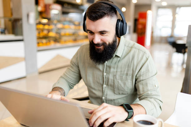 istock Smiling businessman working at cafe 1474891157
