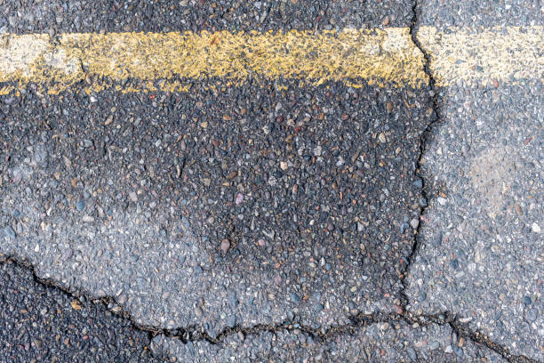 Detail abstract photograph of a cracked asphalt street stock photo