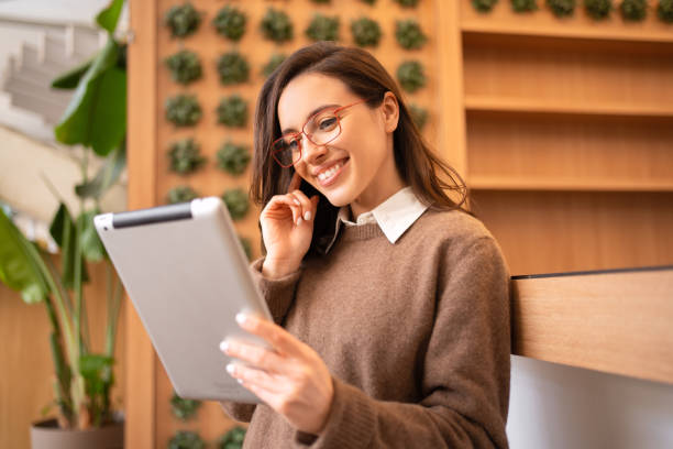 istock Woman in glasses with tablet 1474894892