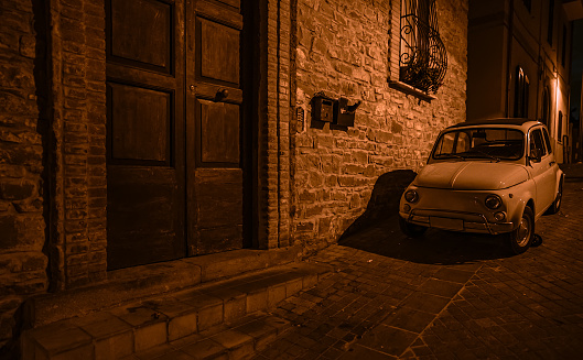 Night street and vintage car in Italy.