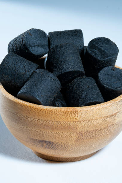 Traditional Finnish cuisine: A bowl of sweet black licorice against a white background stock photo