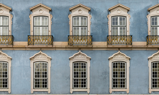 Queluz Palace, Sintra; Portugal; October 20, 2022. Beautiful close-up window details on the exterior palace walls showcasing Rococo styled architecture.