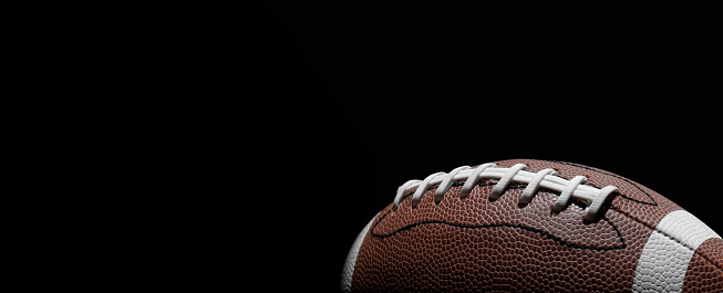 American football ball on gray background. with lots of copy space.