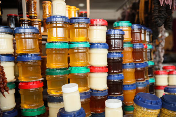istock Jars with aromatic honey and different jams at market 1474901617