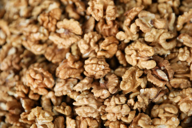 Heap of delicious walnuts as background, closeup view