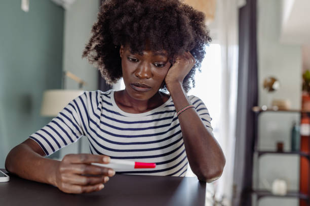istock A Black woman holding a negative pregnancy test 1474901703