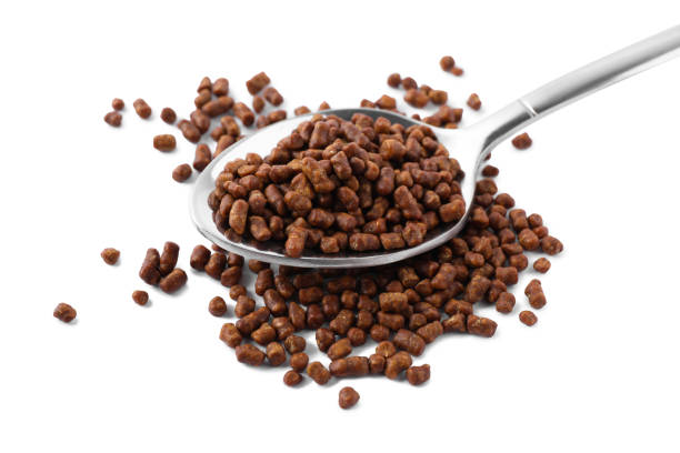 istock Spoon with buckwheat tea granules on white background 1474902264