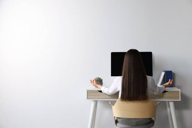 istock Find zen. Woman taking break from work at table indoors, back view. Space for text 1474902901