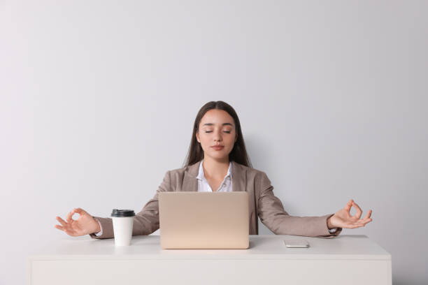 istock Find zen. Woman taking break from work at table near white wall 1474902965