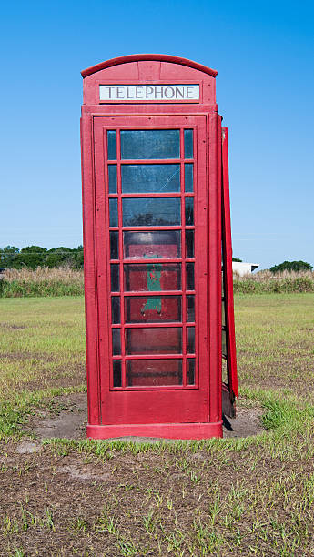istock Vertical Red Traditional English Telephone Booth in Field 147490420