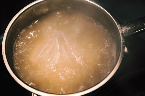 water boiling in a saucepan. to heat water for cooking. boiling water