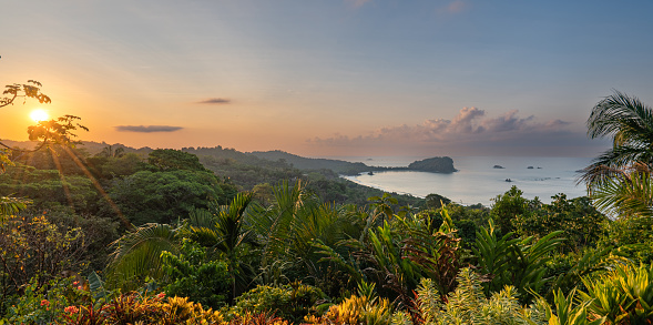 Vibrant sunrise over the wild untamed coastal beauty of Manuel Antonio National Park on the Pacific Coast of Costa Rica.