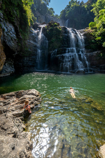 Mother and Toddler Daughter Enjoying the Beautiful Nauyaca Waterfall in the Wild Untamed Coastal Beauty of the Pacific Coast of Costa Rica Mother and toddler daughter enjoying the beautiful Nauyaca Waterfall in the wild untamed coastal beauty of the Pacific Coast of Costa Rica. nauyaca waterfall photos stock pictures, royalty-free photos & images