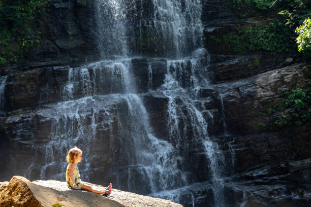 Toddler Girl Enjoying the Beautiful Nauyaca Waterfall in the Wild Untamed Coastal Beauty of the Pacific Coast of Costa Rica Toddler girl enjoying the beautiful Nauyaca Waterfall in the wild untamed coastal beauty of the Pacific Coast of Costa Rica. nauyaca waterfall photos stock pictures, royalty-free photos & images