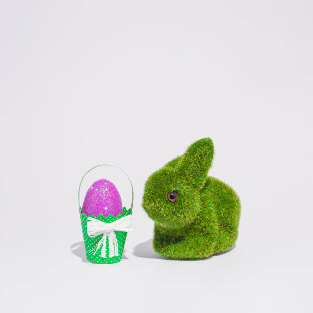 Easter greeting card with purple Easter egg in a paper basket and a bunny rabbit. Minimal holiday background.