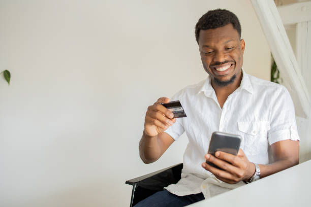 istock Man using her credit card to shop online 1474919713