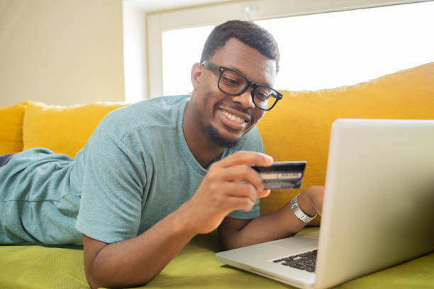 istock Man using her credit card to shop online 1474919721