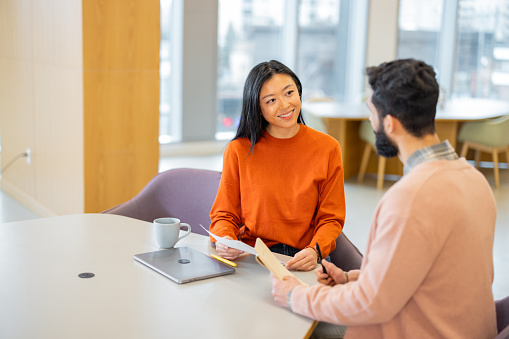 Man consulting with female real estate agent - stock photo