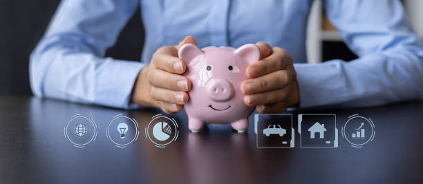 istock Saving money concept. Hand putting coin on pig saving. with growing business graph. Panoramic business banner with copy space. 1474921461
