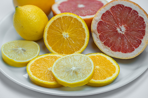 Slices of lemon, grapefruit and orange assorted on a plate