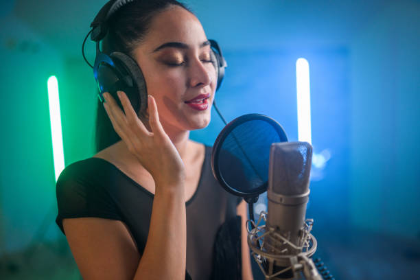 istock Young Asian Beautiful Woman Singing in Recording Studio 1474922913