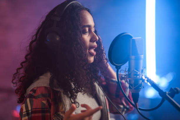 istock Young Hispanic Beautiful Woman Singing in Recording Studio 1474922931