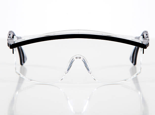 Protective glasses A pair of transparent safety glasses on a white background. protective eyewear stock pictures, royalty-free photos & images