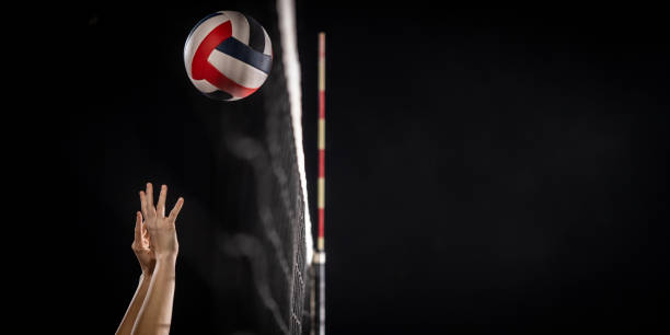 istock Female athletes hands throwing volleyball ball 1474925968