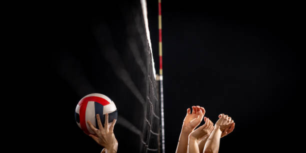 istock Female athletes hands throwing volleyball ball 1474925972
