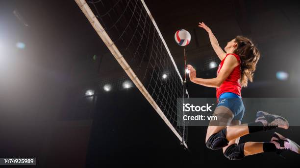 Woman Volleyball Player Kicking Ball Through Net Stock Photo - Download Image Now - Volleyball - Sport, Volleyball - Ball, Only Women