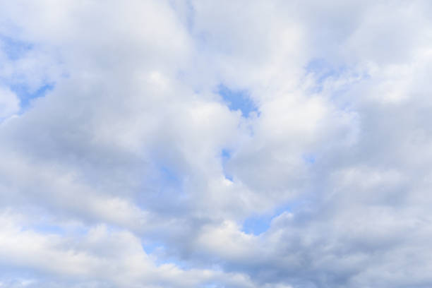 Blue sky with clouds in daylight symbolizing tranquility purity peaceful atmosphere sending a beautiful message from the heavens through nature and clouds during springtime with environmental beauty