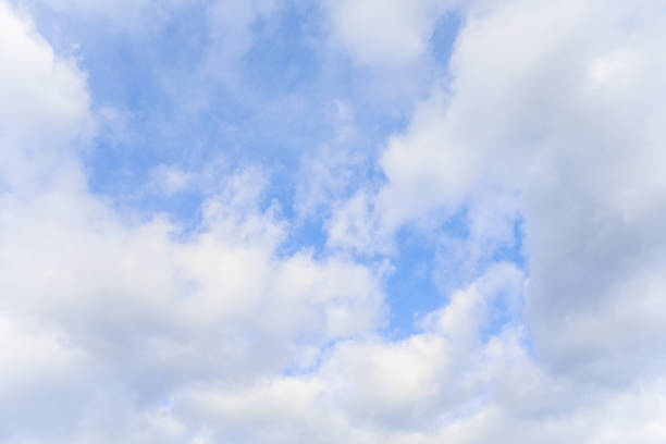 Blue sky with clouds in daylight symbolizing tranquility purity peaceful atmosphere sending a beautiful message from the heavens through nature and clouds during springtime with environmental beauty