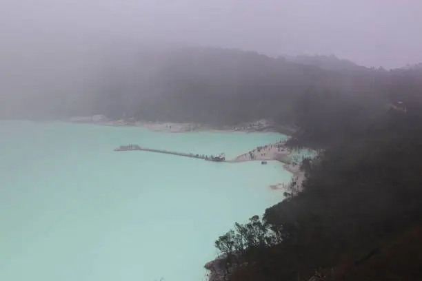 Landscape view of Kawah Putih from the Sunan Ibu Hills which is shrouded in mist in the morning.