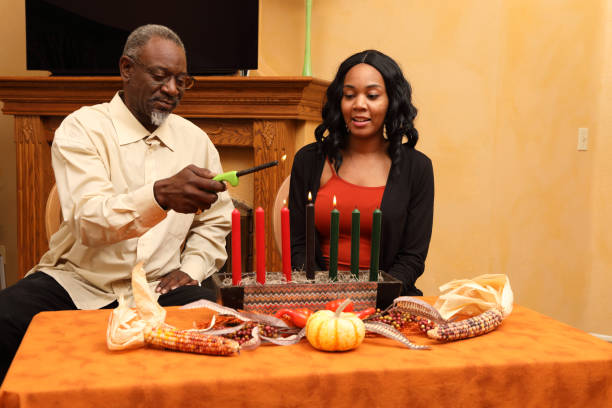 istock Kwanzaa Dad and Daughter Light Candles Together 1474930105