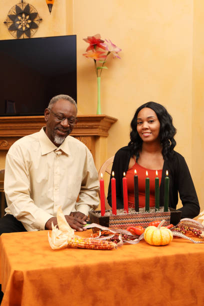 istock Kwanzaa Dad and Daughter Look at Camera Vertical 1474930194