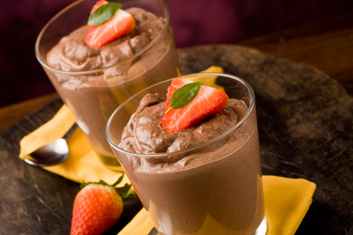 phot of delicious chocolate mousse with strawberries and yellow napkins