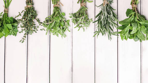 istock Fresh green herbs on white wooden table, top view 1474931226