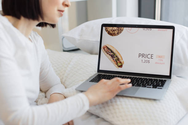 istock Woman using laptop for ordering fast food with discount 1474931434