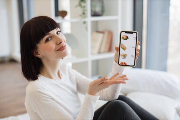 istock Woman using mobile for ordering fast food with discount 1474931557