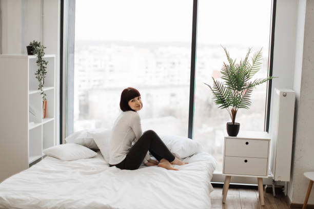 istock Caucasian woman resting at bedroom with panoramic windows 1474932637