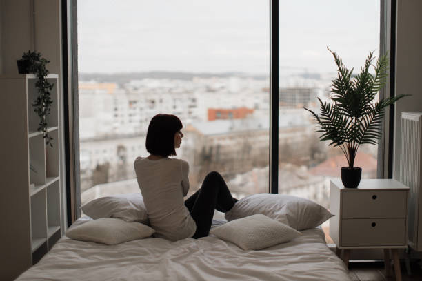 istock Caucasian woman resting at bedroom with panoramic windows 1474932655