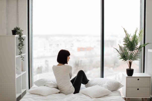 istock Caucasian woman resting at bedroom with panoramic windows 1474932659
