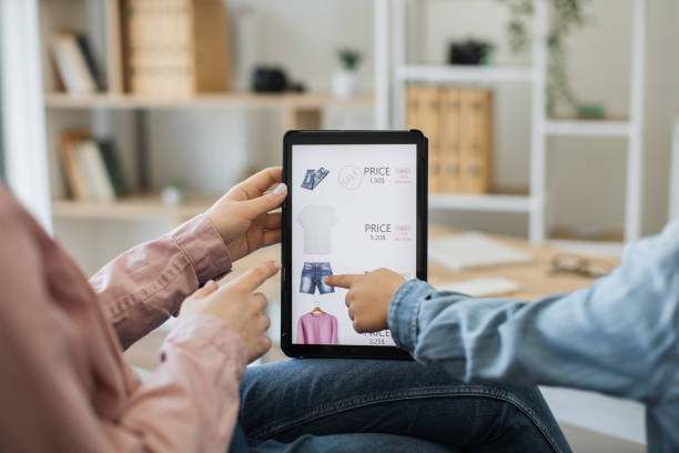 istock Close up of tablet with clothes webstore on screen 1474933403