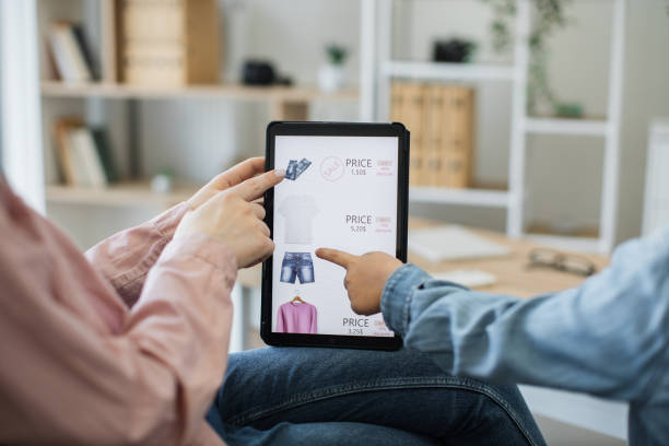 istock Close up of tablet with clothes webstore on screen 1474933406
