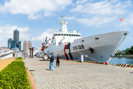 Kaohsiung, Taiwan- June 9, 2022: Tourists visit the Pier-2 Art Center in the port of Kaohsiung, Taiwan; with the Patrol ships of Taiwan Coast Guard anchored by the harbor.