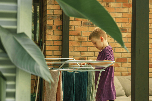A boy helps with his family laundering ￼