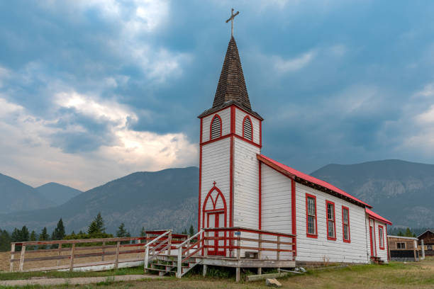 moody skies over a roman catholic mission church outside invermere, bc - ktunaxa imagens e fotografias de stock