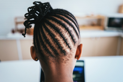 Rear view of African girl with braided hair at studio