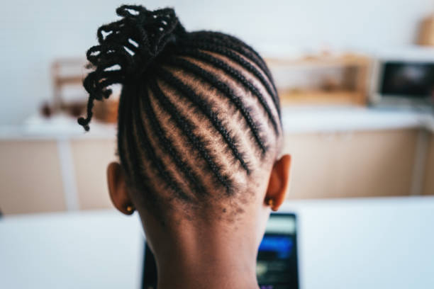 Rear view of African girl with braided hair Rear view of African girl with braided hair at studio black hair braiding stock pictures, royalty-free photos & images