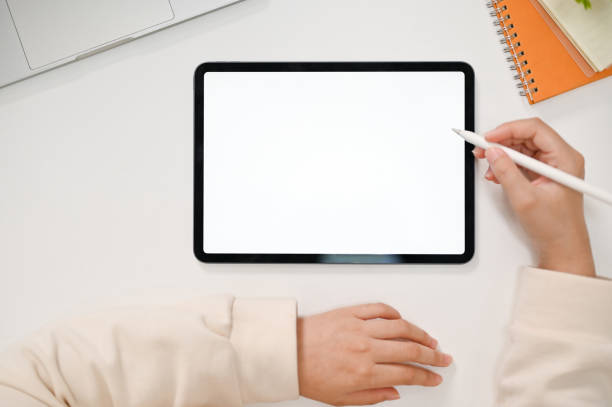 istock Top view of a female using digital tablet to sketch her artwork. tablet white screen mockup 1474940952